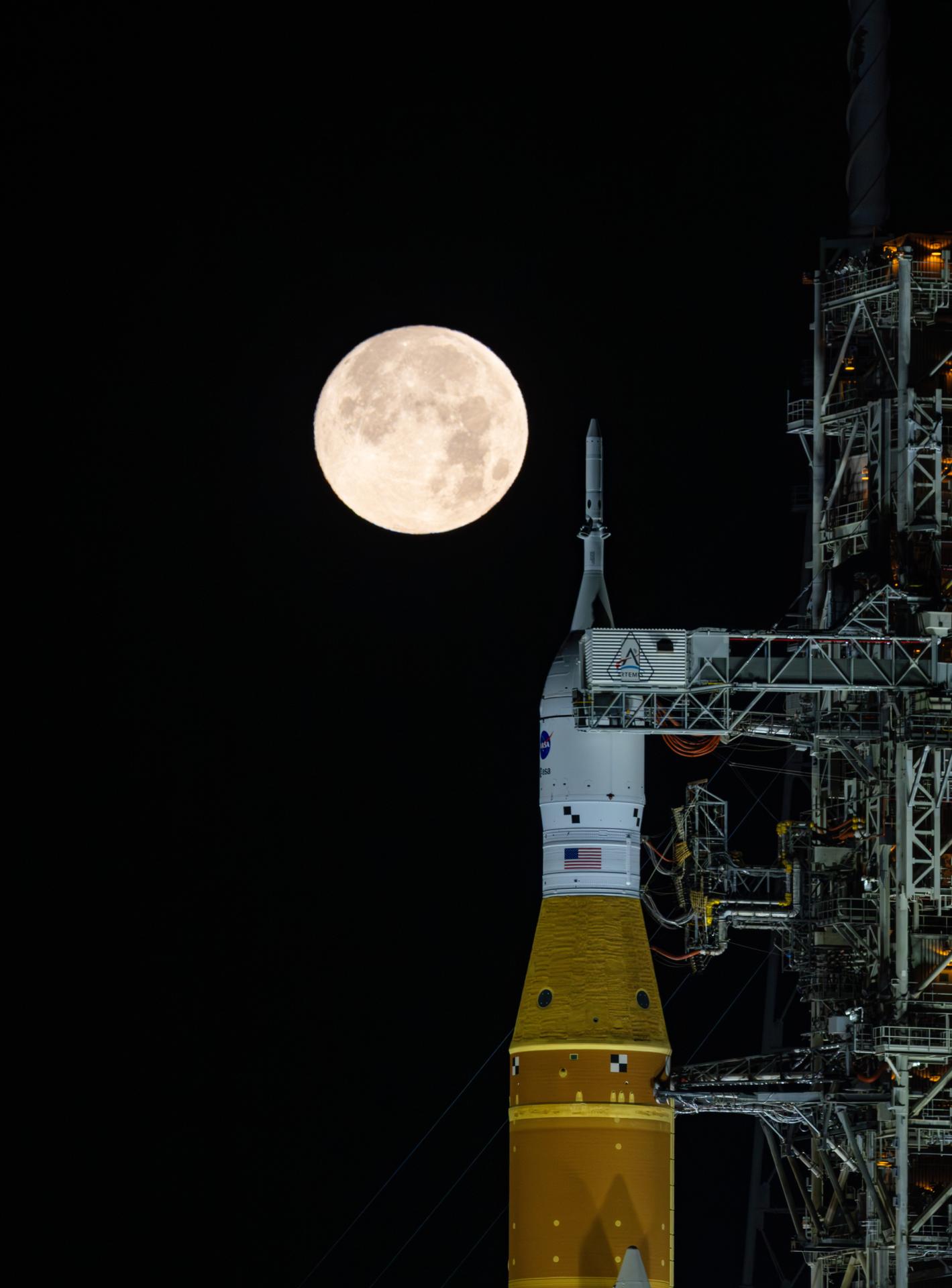 A full Moon is seen shining over NASA’s SLS (Space Launch System) and Orion spacecraft, atop the mobile launcher in the early hours of February 1, 2026. The rocket is currently at Launch Pad 39B at NASA’s Kennedy Space Center in Florida, as teams are preparing for a wet dress rehearsal to practice timelines and procedures for the launch of Artemis II.